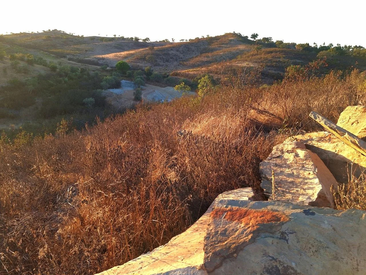 Evening sun on the hills and the schist slabs of the land