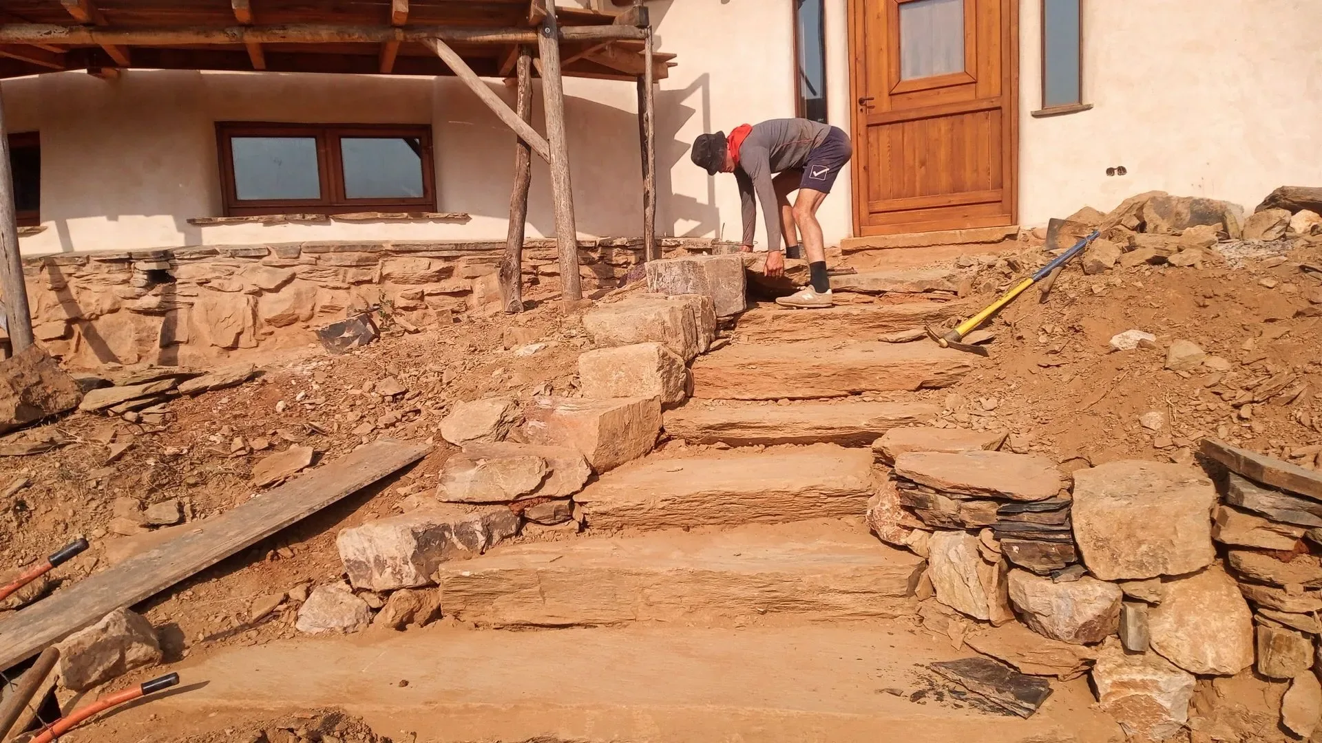 Stone steps and paved terrace leading to a house